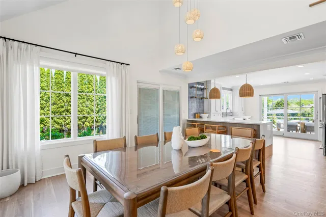 a kitchen with a table chairs a sink and a window