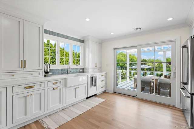 a large white kitchen with a large window