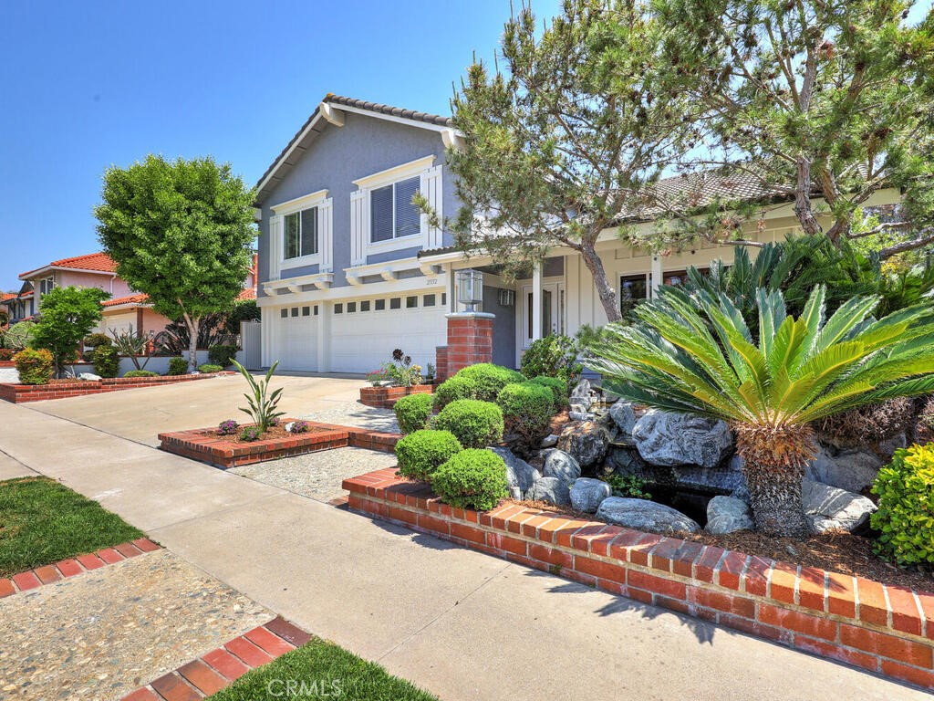 a front view of a house with a yard and outdoor seating