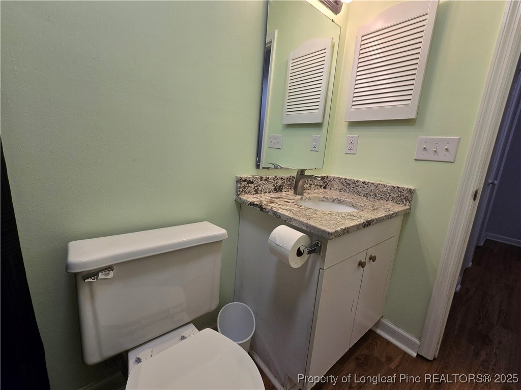 944 Flintwood Road Fayetteville, NC 28314 - Photo 18 of 24 a bathroom with a granite countertop toilet sink and mirror