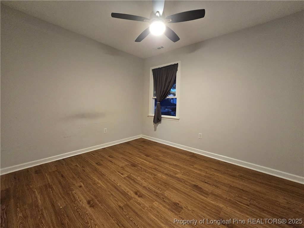 944 Flintwood Road Fayetteville, NC 28314 - Photo 19 of 24 a view of empty room with wooden floor and fan