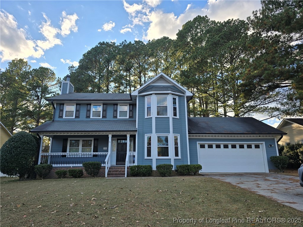 944 Flintwood Road Fayetteville, NC 28314 - Photo 2 of 24 a front view of a house with a garden and trees