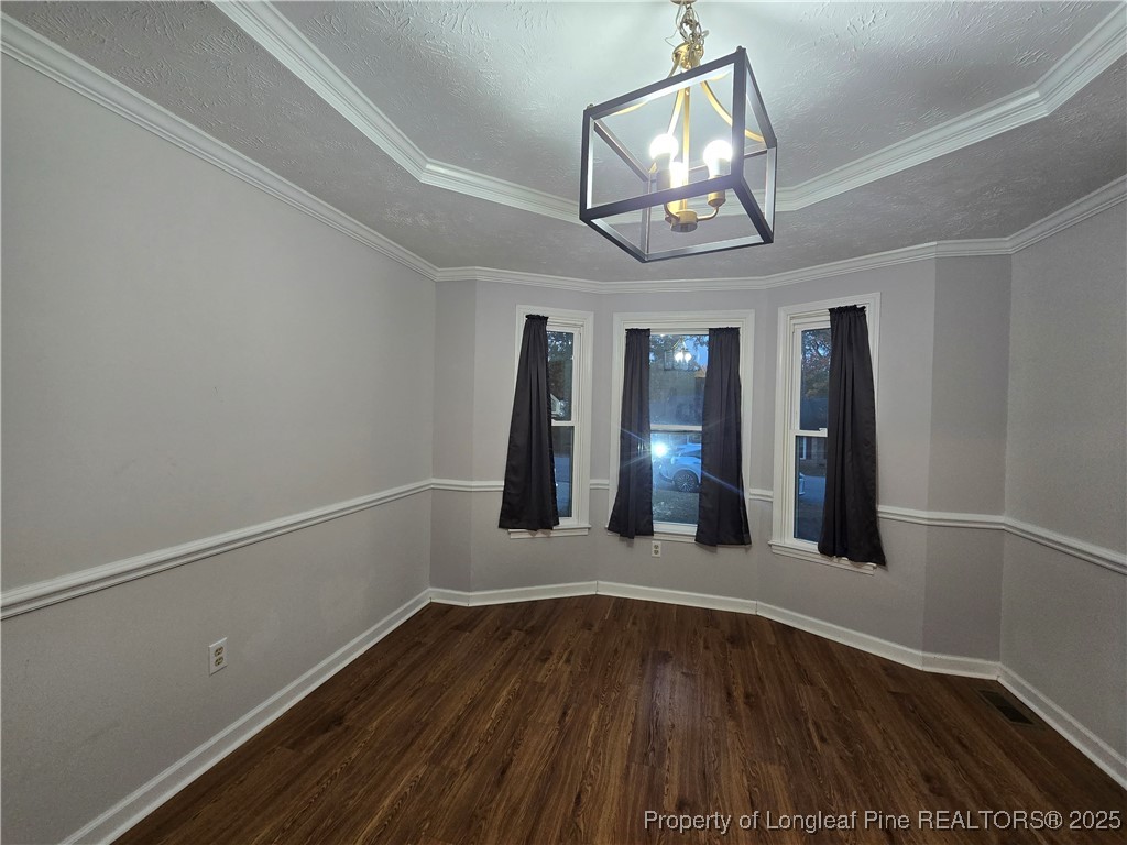 944 Flintwood Road Fayetteville, NC 28314 - Photo 7 of 24 a view of an empty room with wooden floor and a window