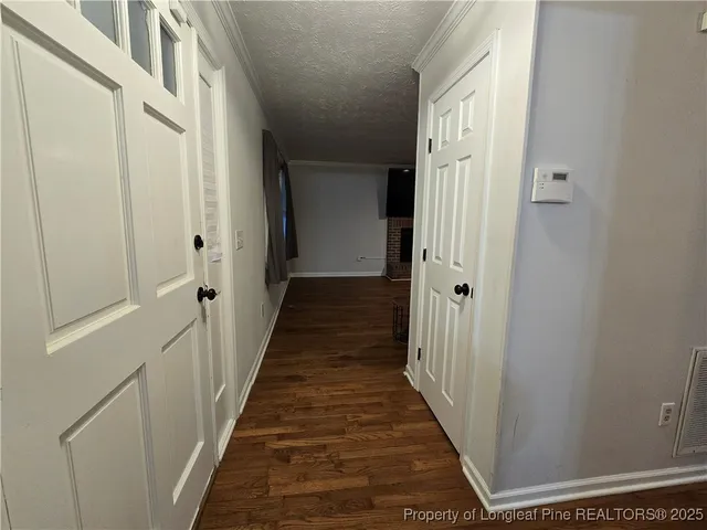a view of a hallway with a wooden door