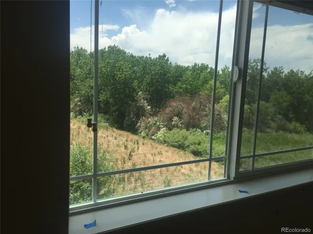 a view of a glass door and a yard from a window