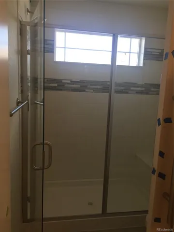 a bathroom with a glass shower door