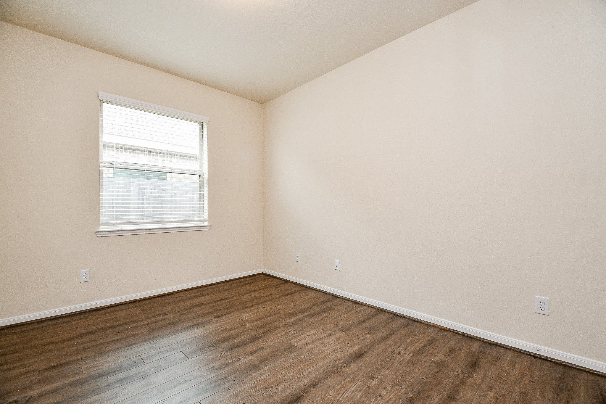 15210 Ordie Run Drive Humble, TX 77346 - Photo 23 of 40 an empty room with wooden floor and windows