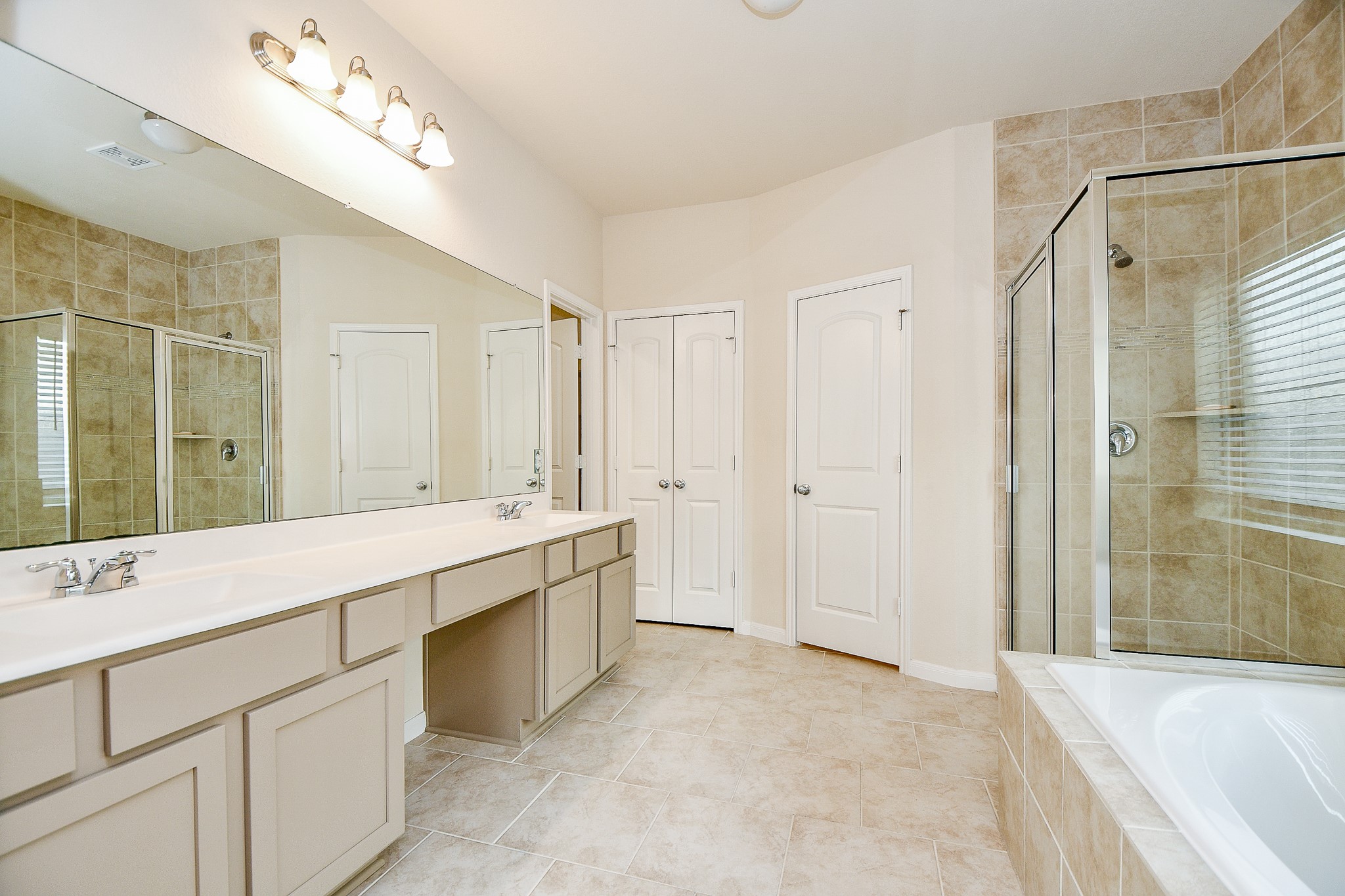 15210 Ordie Run Drive Humble, TX 77346 - Photo 27 of 40 a view of a bathroom with a sink mirror and a bathtub