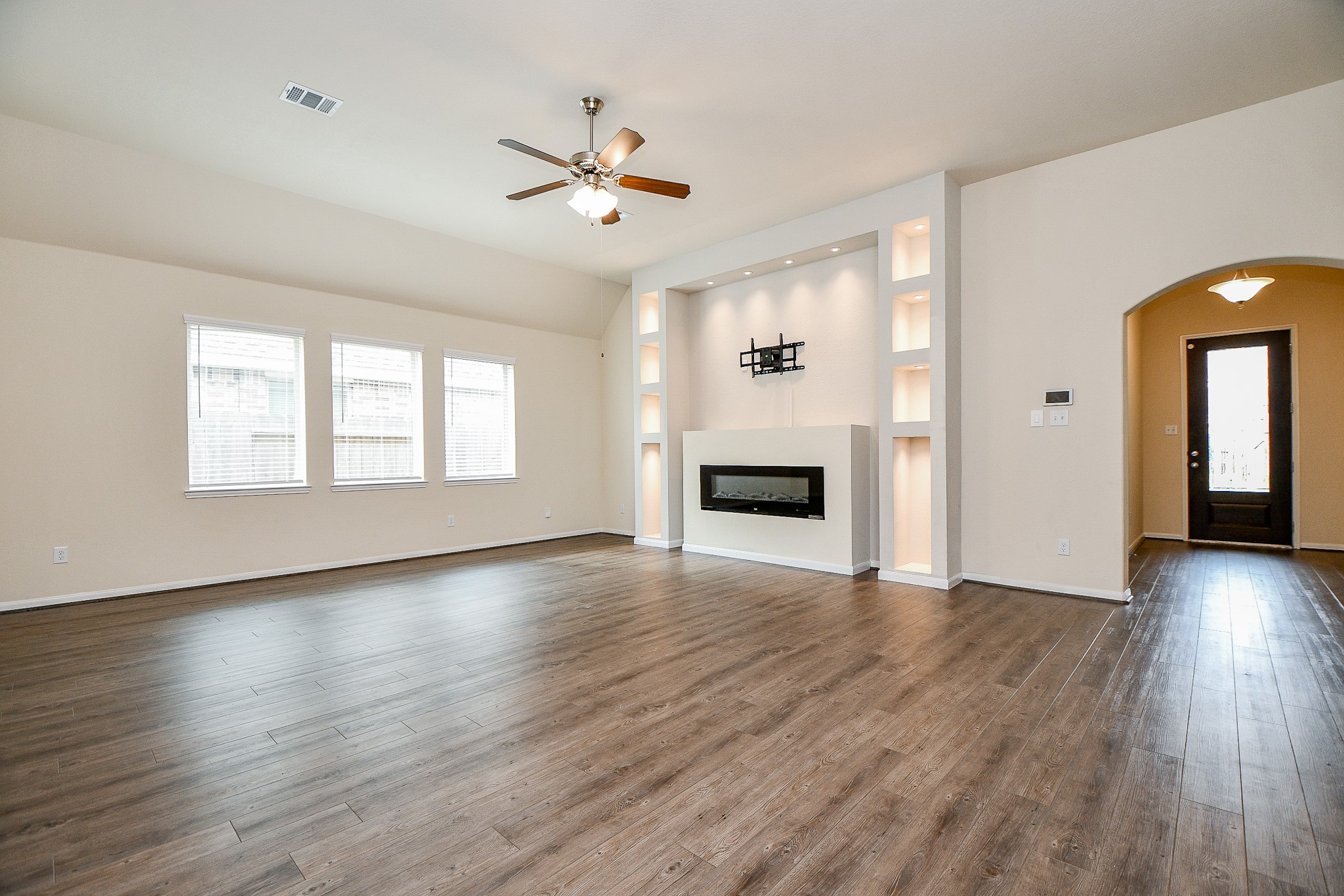 15210 Ordie Run Drive Humble, TX 77346 - Photo 5 of 40 a view of an empty room with wooden floor and a window