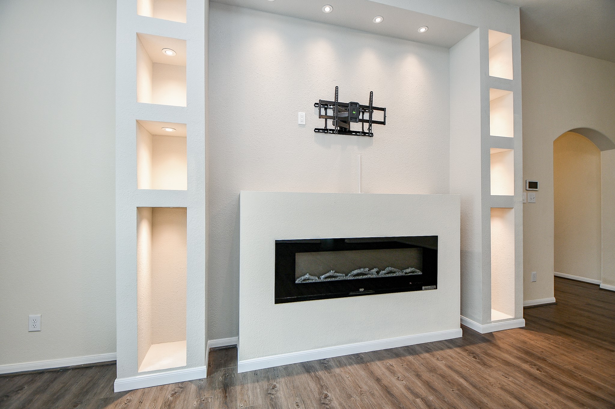 15210 Ordie Run Drive Humble, TX 77346 - Photo 6 of 40 a view of an empty room with wooden floor and a fireplace