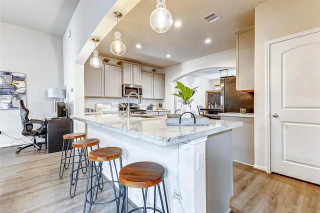 a view of a kitchen counter space and wooden floor
