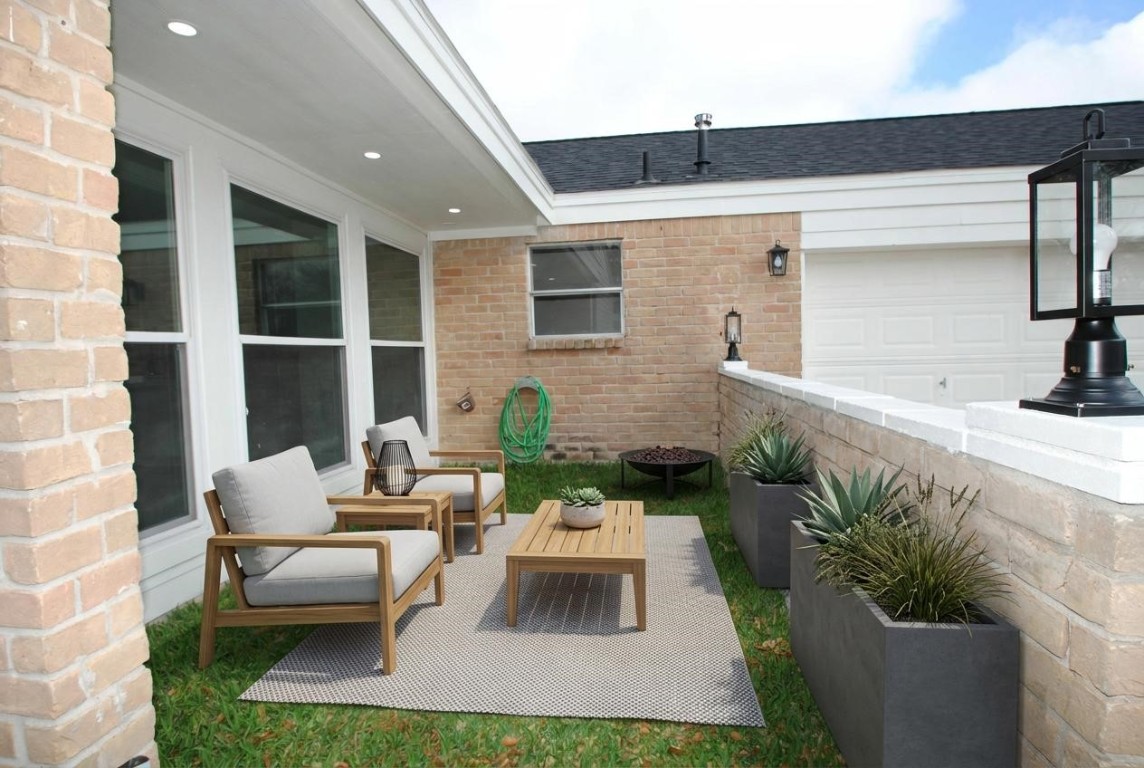3322 Robinson Road Missouri City, TX 77459 - Photo 24 of 27 a view of a patio with couches table and chairs and potted plants
