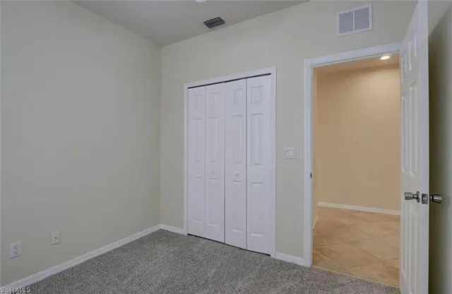 an empty room with closet area