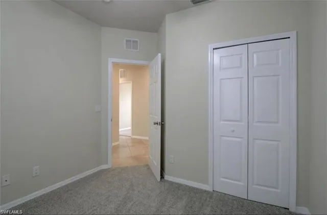 a view of an empty room with closet area