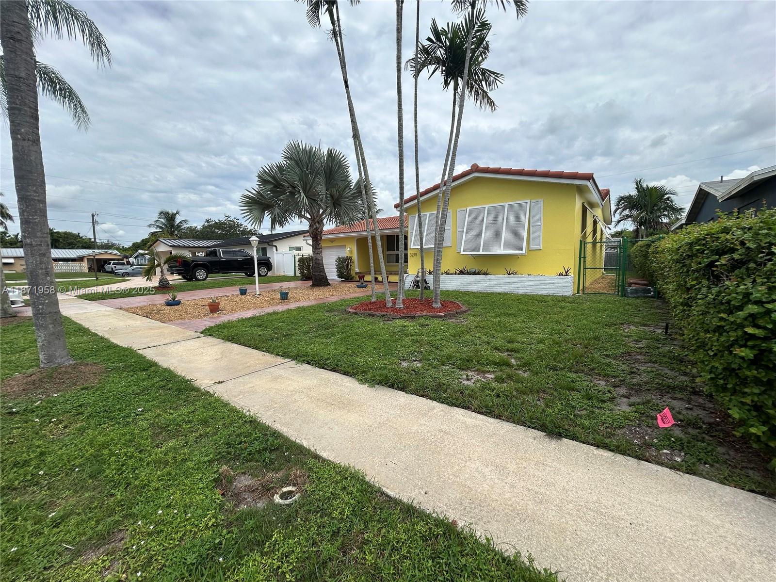 3219 Wilson Street Hollywood, FL 33021 - Photo 2 of 15 a front view of house with yard and green space