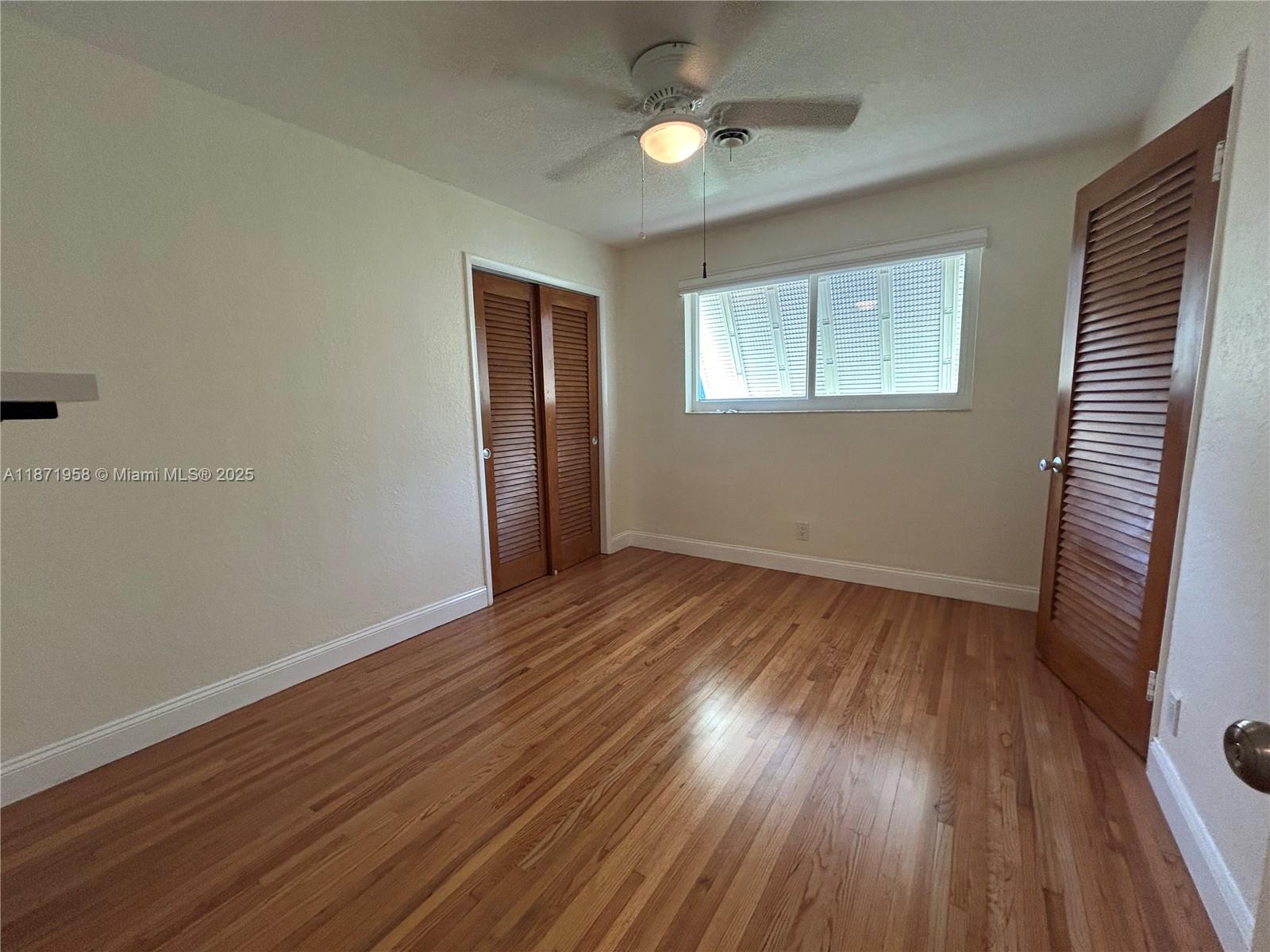 3219 Wilson Street Hollywood, FL 33021 - Photo 10 of 15 a view of an empty room with wooden floor and a window