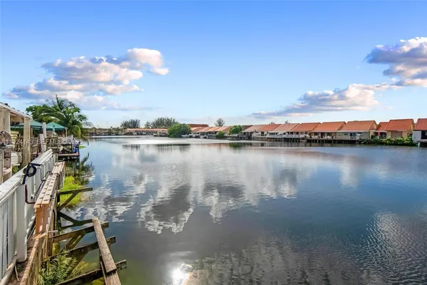 a view of a lake with lawn chairs