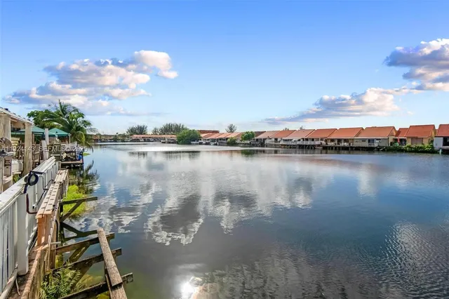 a view of a lake with lawn chairs