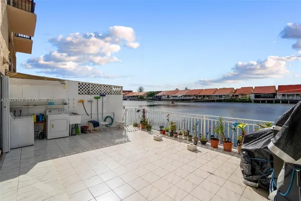 a view of roof deck with chair and a barbeque
