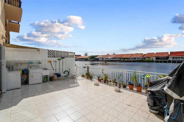 a view of roof deck with chair and a barbeque
