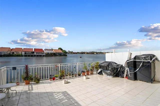 a view of a lake with tables and chairs