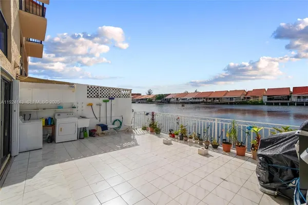 a view of a patio with couches near an ocean