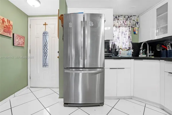 a white refrigerator freezer sitting in a kitchen