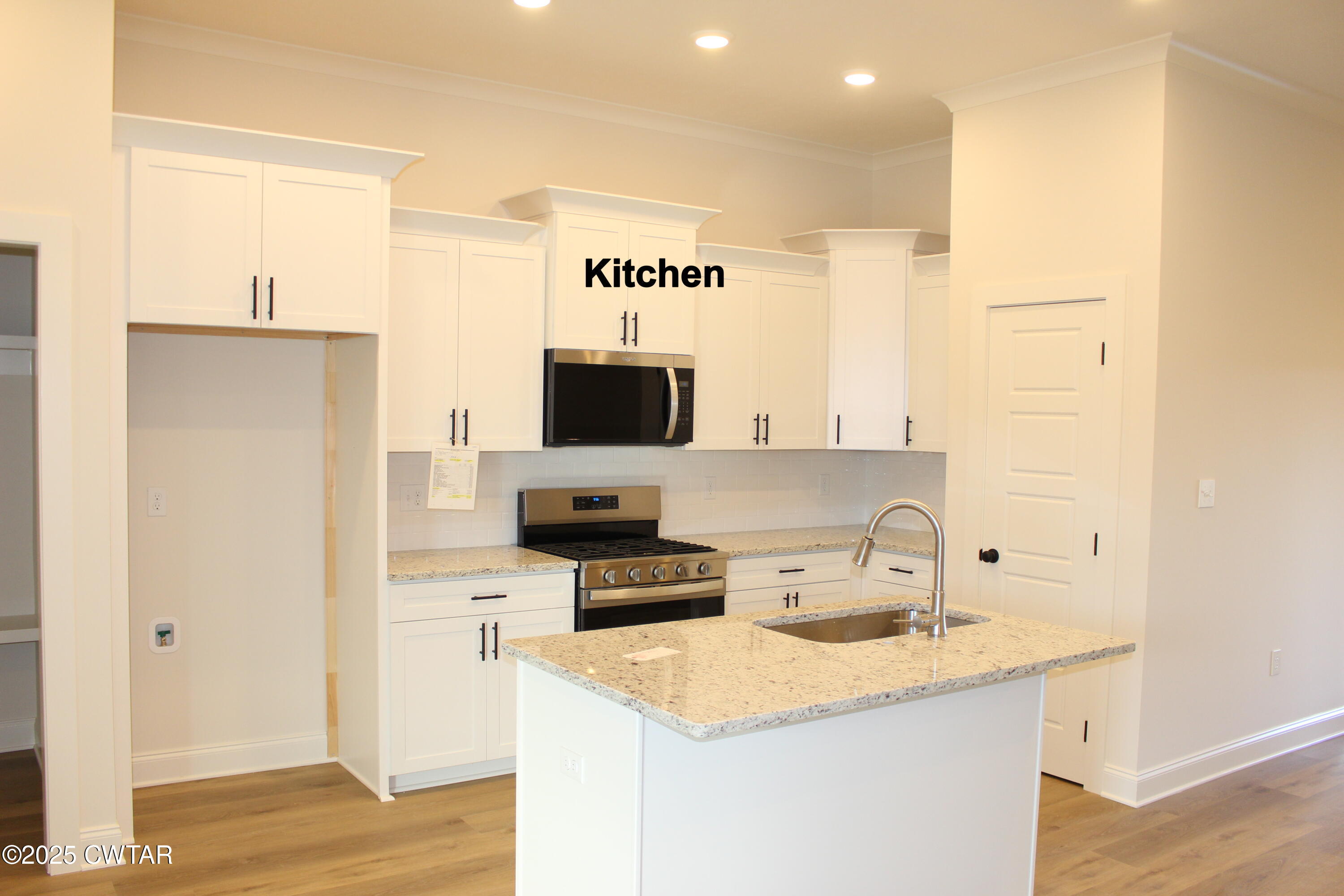 57 Brompton Cove Jackson, TN 38305 - Photo 3 of 15 a kitchen with a sink a counter top space and cabinets