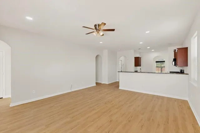 a view of a kitchen with a sink and a refrigerator