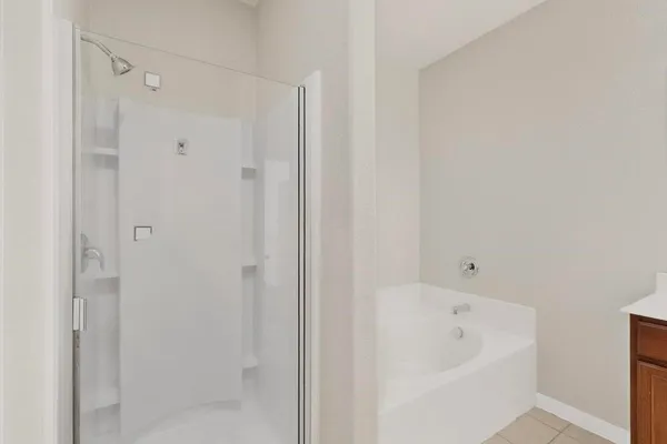 a bathroom with a tub sink and mirror