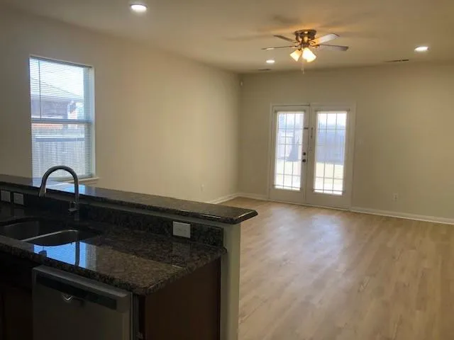 a view of a kitchen with a sink cabinet and a window