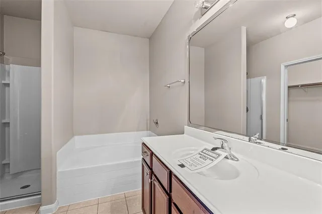 a bathroom with a tub sink and mirror