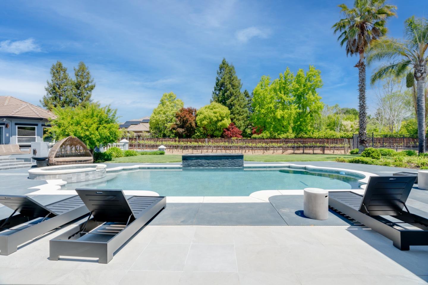 1940 Pear Drive Morgan Hill, CA 95037 - Photo 27 of 36 a view of swimming pool with seating space and trees in the background