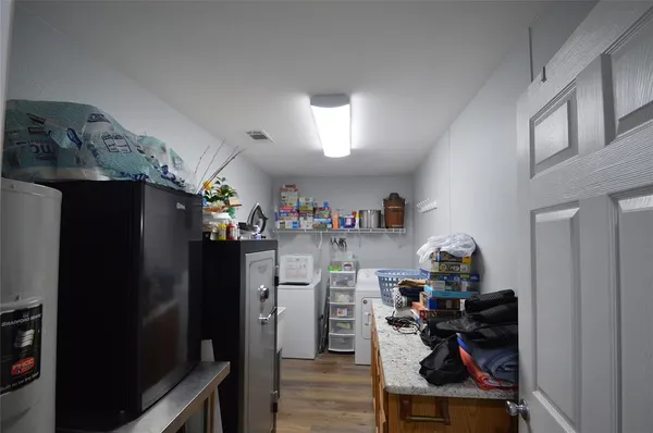 a kitchen with a refrigerator and cabinets