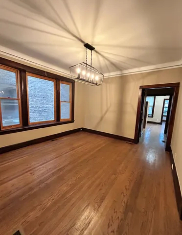 a view of empty room with wooden floor and fireplace