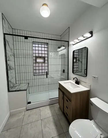 a bathroom with a toilet sink and mirror