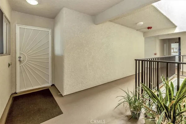 a view of a hallway with entryway door