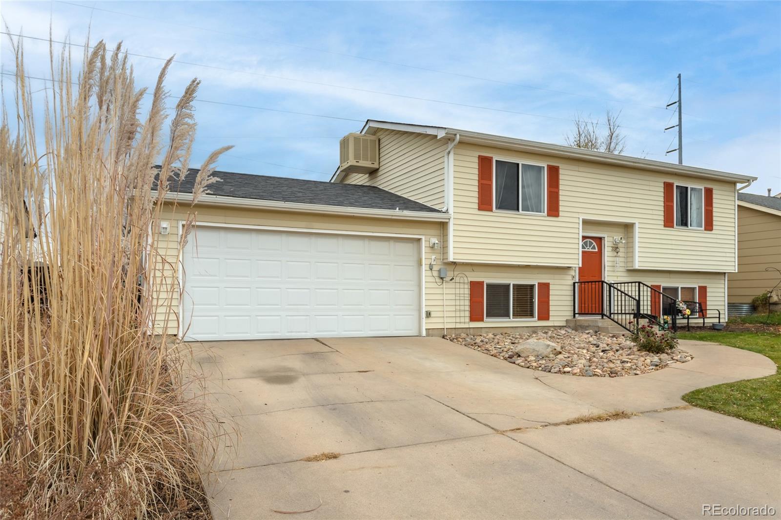 3192 West 3rd Street Road Greeley, CO 80631 - Photo 1 of 31 a front view of a house with a yard and garage