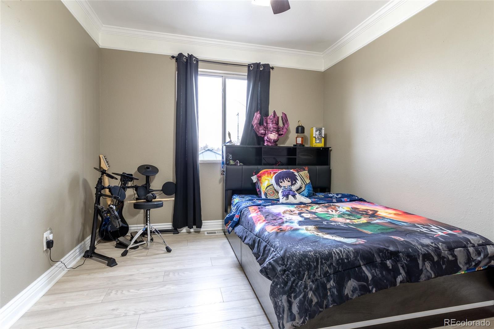 3192 West 3rd Street Road Greeley, CO 80631 - Photo 15 of 31 a bed sitting in a bedroom next to a window