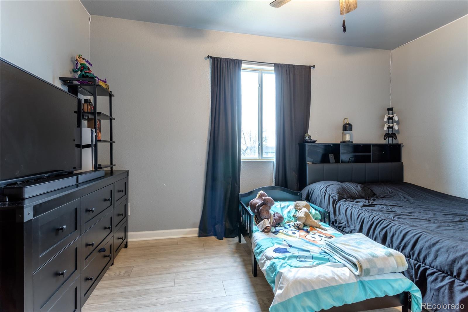 3192 West 3rd Street Road Greeley, CO 80631 - Photo 18 of 31 a bedroom with furniture and a flat screen tv