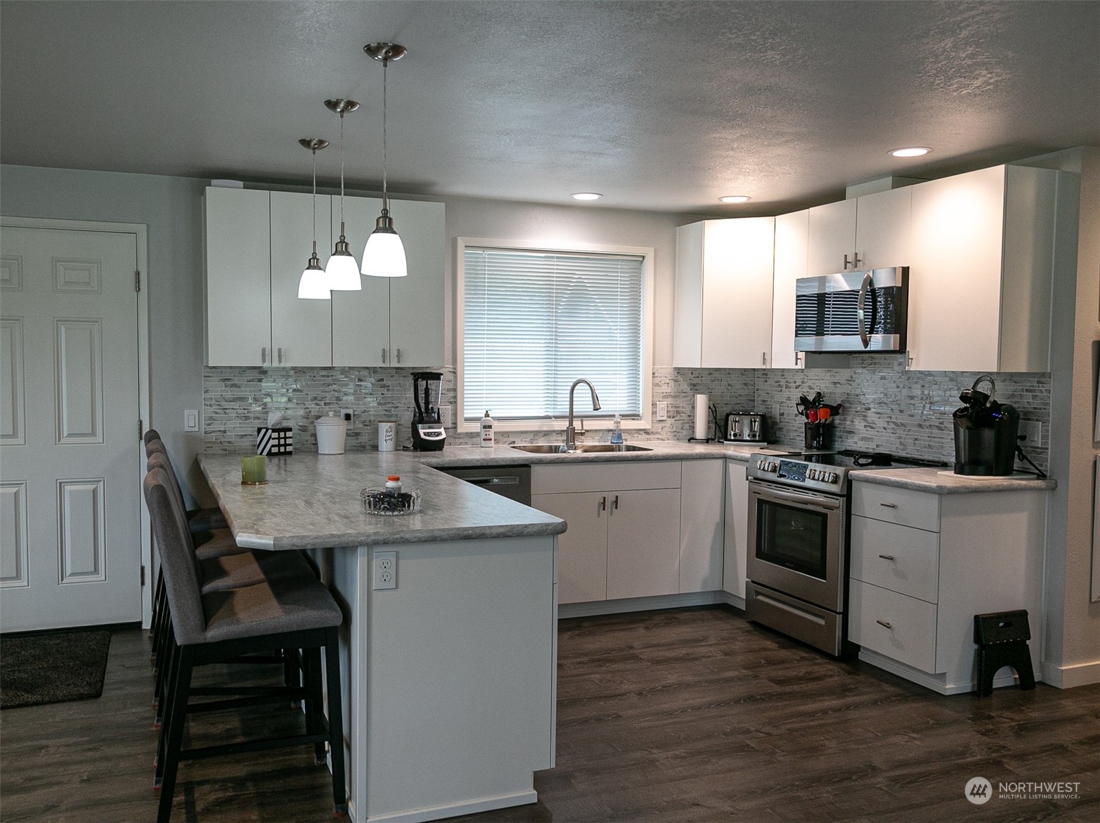240 Osborn Road Port Angeles, WA 98362 - Photo 7 of 37 a kitchen with a sink cabinets and wooden floor