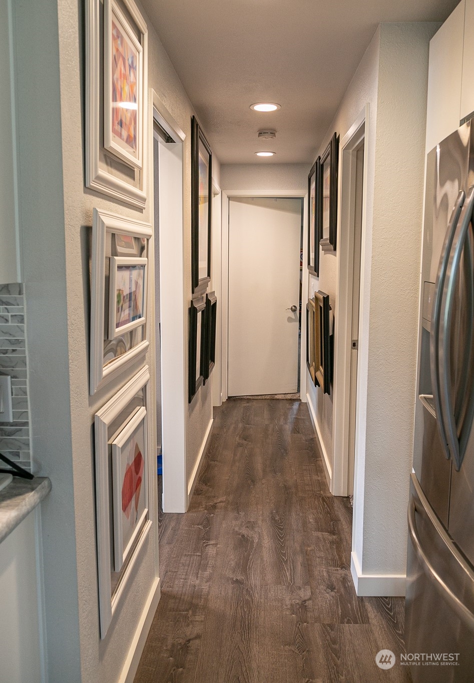 240 Osborn Road Port Angeles, WA 98362 - Photo 9 of 37 a view of a hallway with stainless steel appliances refrigerator stove and cabinets