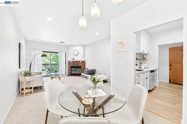 a living room with furniture a fireplace and a table