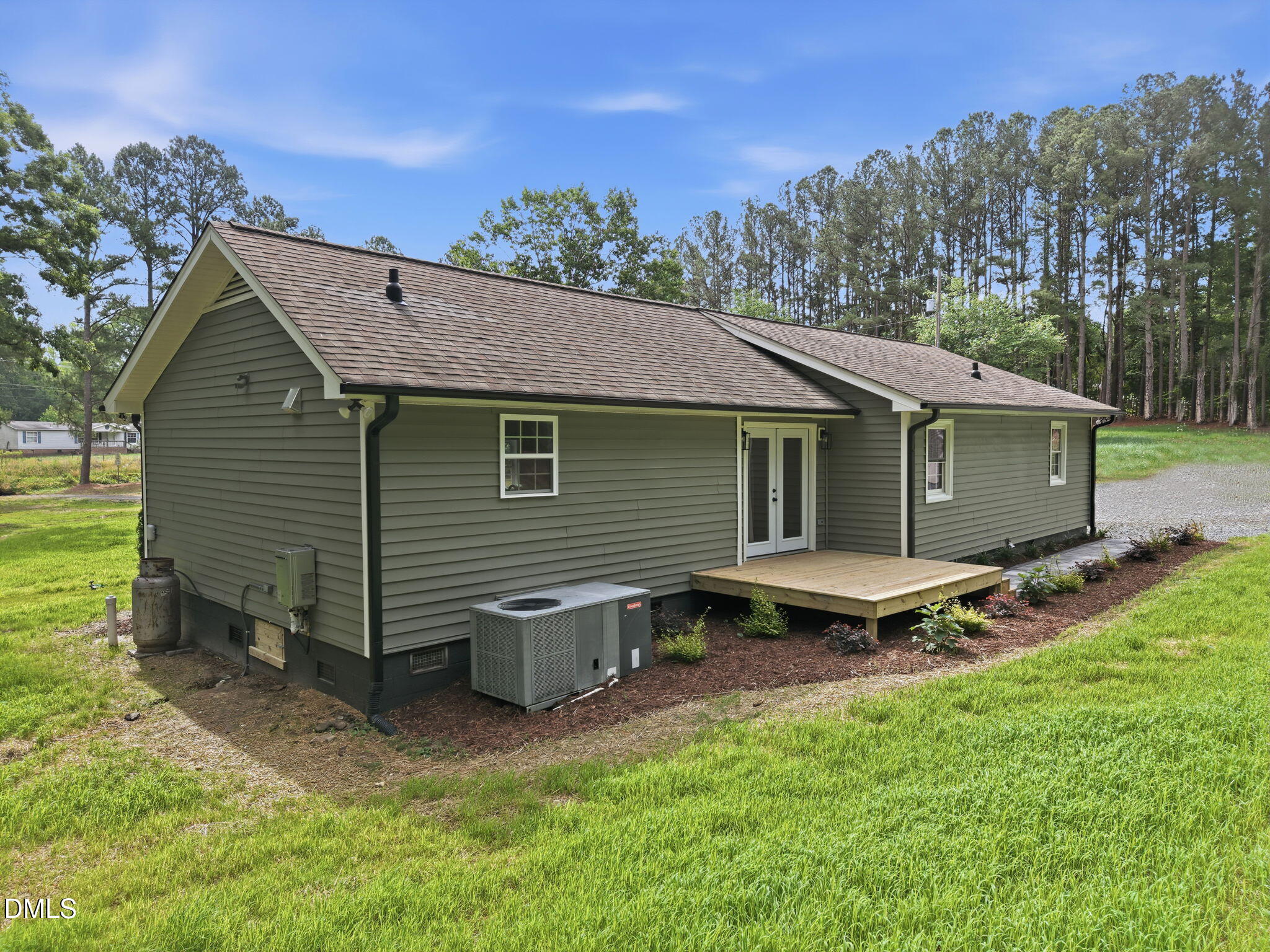 4105 Culbreth Road Stem, NC 27581 - Photo 31 of 41 a view of a backyard with table and chairs and a large tree