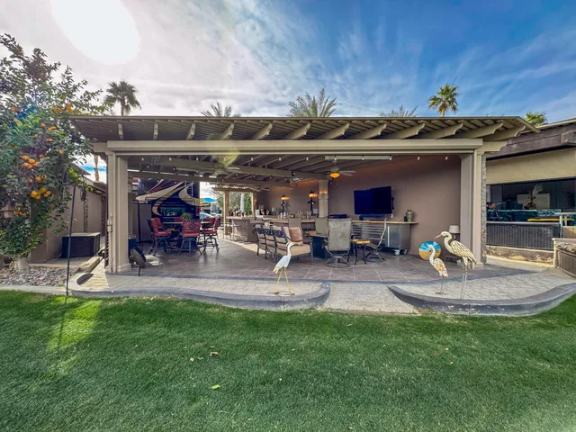 a view of a backyard with table and chairs and a slide