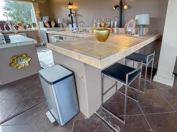 a kitchen with a sink a stove and chairs