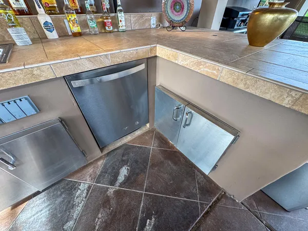 a kitchen with a sink a stove and cabinets
