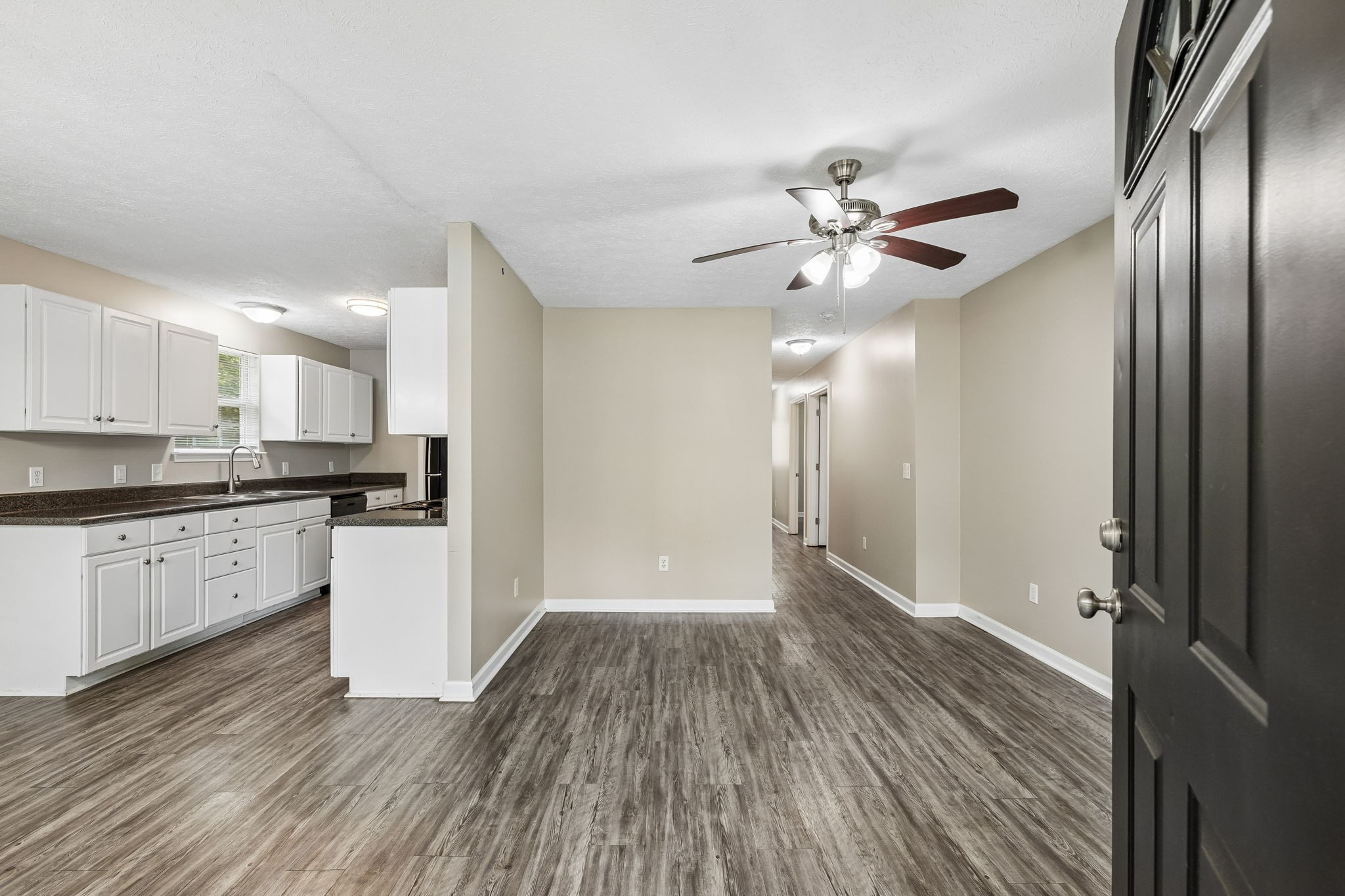 511 Hayes Street Springfield, TN 37172 - Photo 4 of 26 a view of an empty room and kitchen with wooden floor