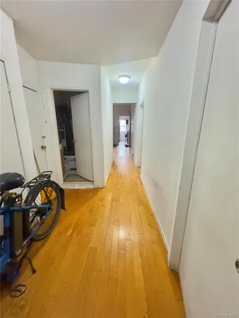 a view of a room with wooden floor