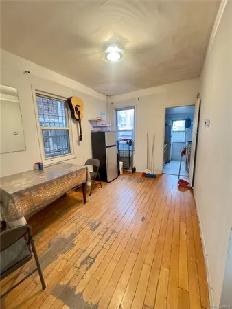 a view of a room with furniture and wooden floor